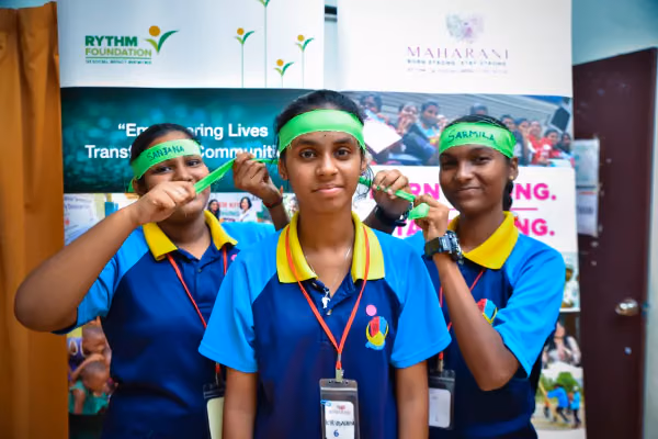 Rythm 10 three athlete girls staring at the camera with green headbands